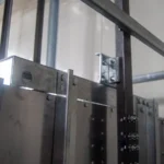 Electric commercial dumbwaiter unit showing the motor and control system that need regular maintenance