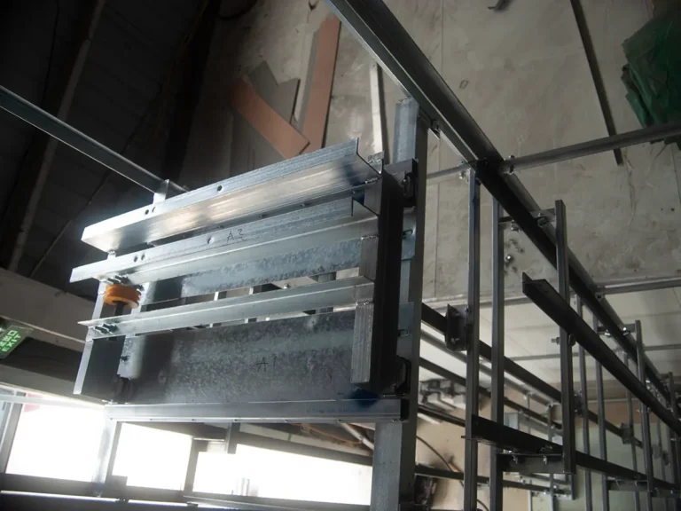 Dumbwaiter door types shown on a traction service lift with interlocking landing doors